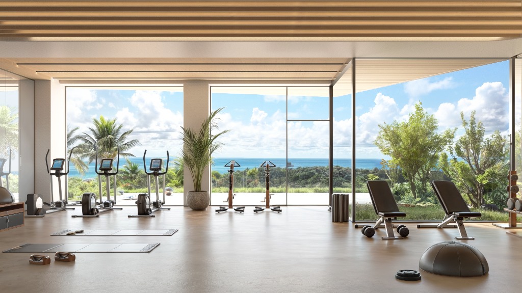Gimnasio wellness de The Gem equipado con máquinas Technogym, pesas libres y amplias ventanas con luz natural